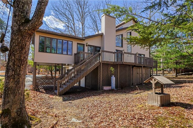 367 Saunders Dr, Lehman Twp, PA 18324 - back of property with stairs, a chimney, and a deck