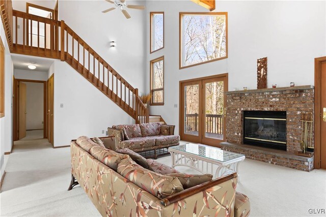 367 Saunders Dr, Lehman Twp, PA 18324 - carpeted living area with a brick fireplace, stairs, and ceiling fan