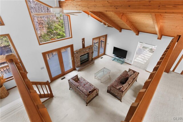 367 Saunders Dr, Lehman Twp, PA 18324 - living room featuring high vaulted ceiling, beamed ceiling, a ceiling fan, a glass covered fireplace, and wooden ceiling
