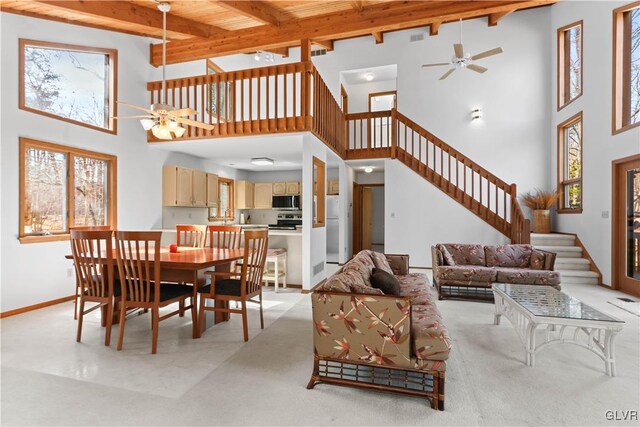 367 Saunders Dr, Lehman Twp, PA 18324 - dining space with beam ceiling, stairway, and a ceiling fan