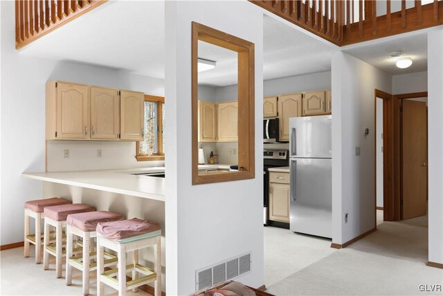 367 Saunders Dr, Lehman Twp, PA 18324 - kitchen featuring light countertops, a kitchen bar, visible vents, light brown cabinets, and appliances with stainless steel finishes