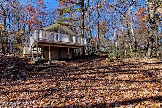 exterior space featuring stairs and a wooden deck