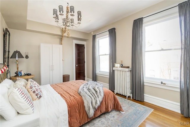 1527 W Turner St, Allentown City, PA 18102 - bedroom with radiator heating unit, a chandelier, light wood finished floors, and baseboards