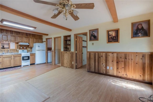 kitchen featuring light wood-style flooring, beamed ceiling, white appliances, a ceiling fan, and under cabinet range hood