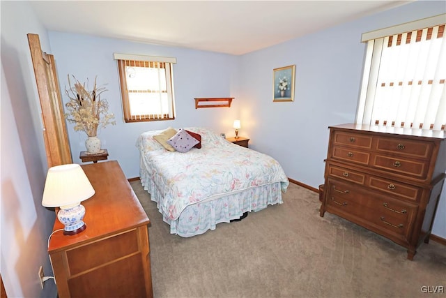 bedroom with carpet floors and baseboards