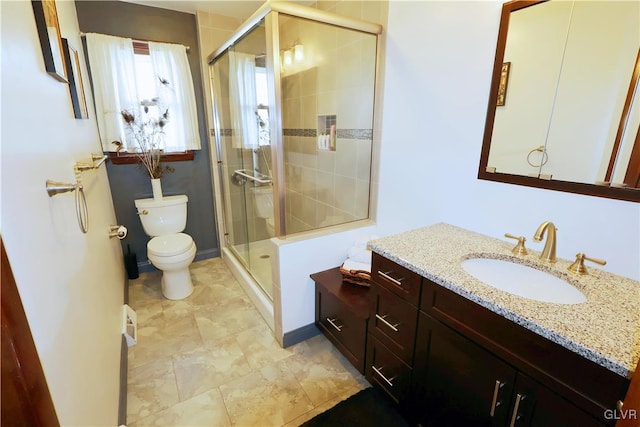 full bath with toilet, a stall shower, and vanity