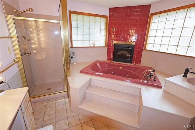 full bathroom featuring a whirlpool tub, a stall shower, tile patterned flooring, and a fireplace