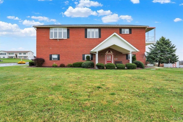 view of front of house with a front lawn and brick siding