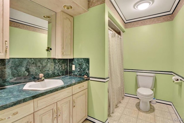 full bath featuring tasteful backsplash, toilet, vanity, and baseboard heating