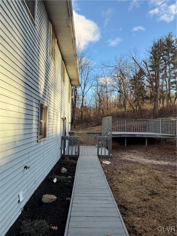 view of property exterior with a deck