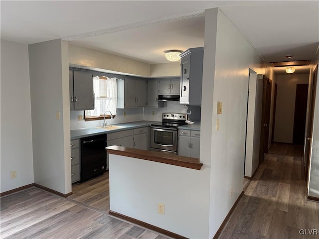 kitchen with black dishwasher, stainless steel range with electric stovetop, a sink, under cabinet range hood, and gray cabinetry