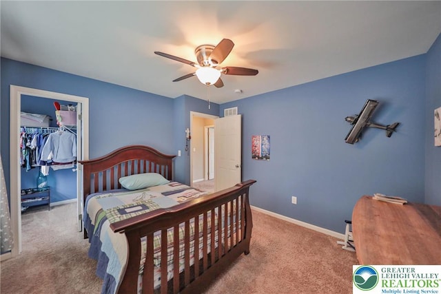 bedroom featuring a closet, a spacious closet, visible vents, carpet flooring, and baseboards