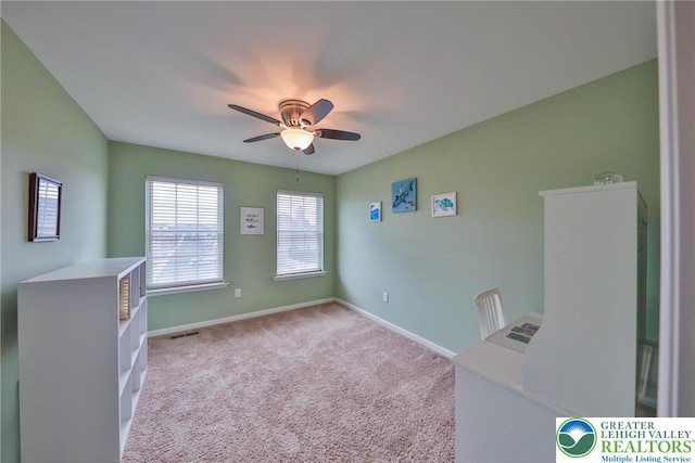 empty room featuring visible vents, baseboards, a ceiling fan, and carpet floors
