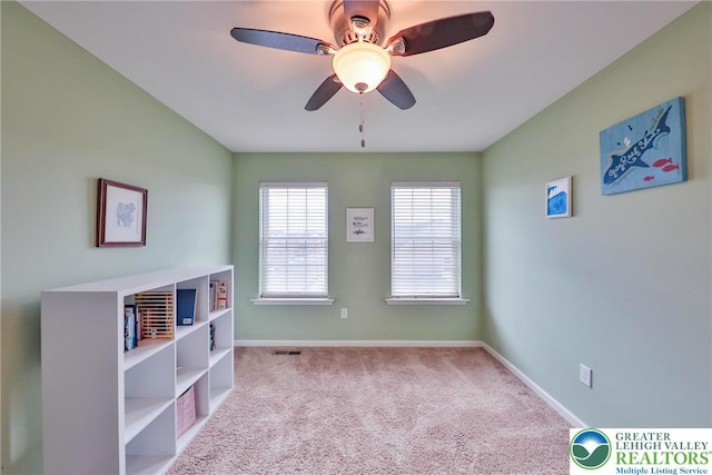 carpeted empty room featuring ceiling fan, baseboards, and visible vents