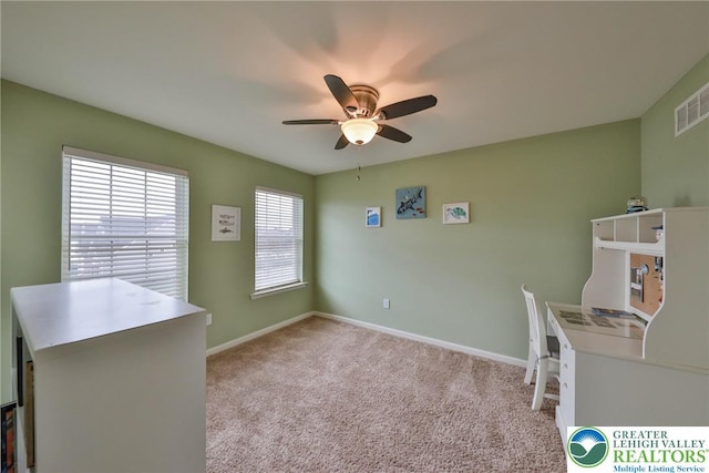 unfurnished office with light carpet, visible vents, baseboards, and ceiling fan