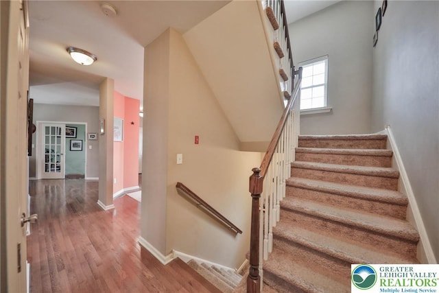 stairs with baseboards and wood finished floors