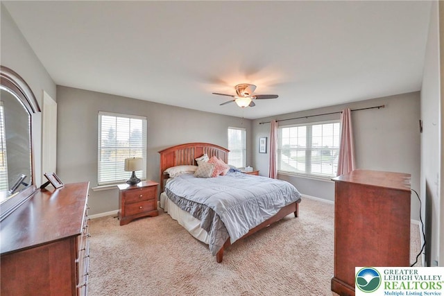 bedroom with baseboards, a ceiling fan, and light carpet