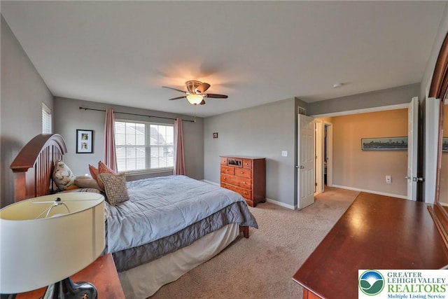 bedroom with baseboards, ceiling fan, and light carpet