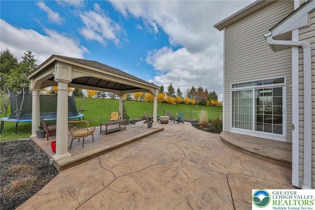 view of patio featuring a trampoline and a gazebo