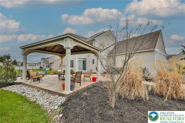 rear view of property with a gazebo and a patio