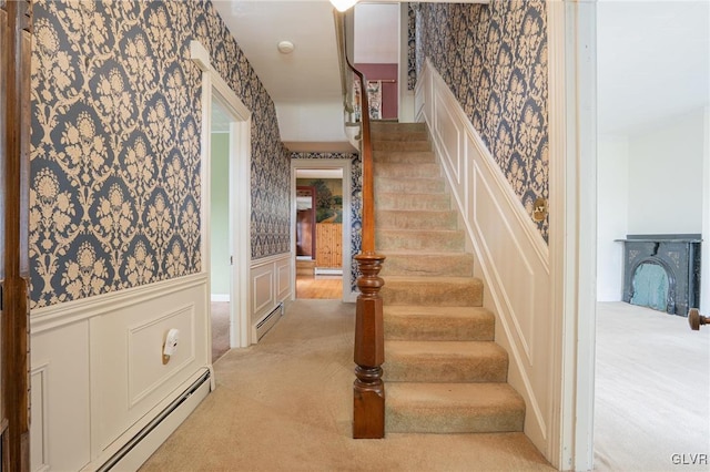 221 Franklin St, Alburtis Borough, PA 18011 - stairway featuring a baseboard radiator, wainscoting, and wallpapered walls
