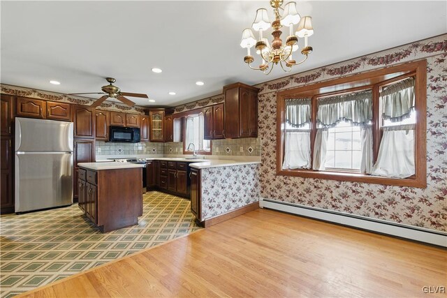 221 Franklin St, Alburtis Borough, PA 18011 - kitchen with light wood-style floors, light countertops, a baseboard radiator, and stainless steel appliances