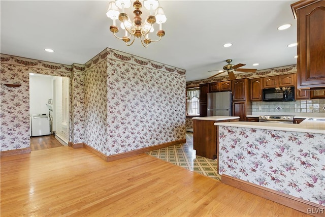 221 Franklin St, Alburtis Borough, PA 18011 - kitchen featuring light countertops, freestanding refrigerator, electric stove, black microwave, and light wood finished floors