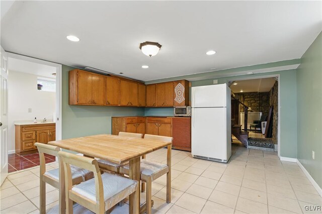 221 Franklin St, Alburtis Borough, PA 18011 - kitchen featuring freestanding refrigerator, recessed lighting, light tile patterned flooring, brown cabinets, and baseboards