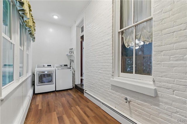 221 Franklin St, Alburtis Borough, PA 18011 - clothes washing area with brick wall, laundry area, baseboard heating, dark wood-type flooring, and washing machine and clothes dryer