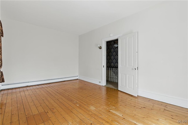 221 Franklin St, Alburtis Borough, PA 18011 - empty room with light wood-style flooring, a baseboard heating unit, and baseboards