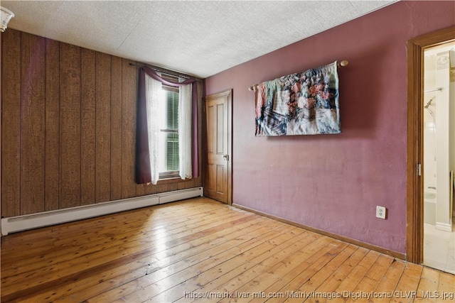 221 Franklin St, Alburtis Borough, PA 18011 - spare room with a baseboard radiator, hardwood / wood-style floors, baseboards, and a textured ceiling