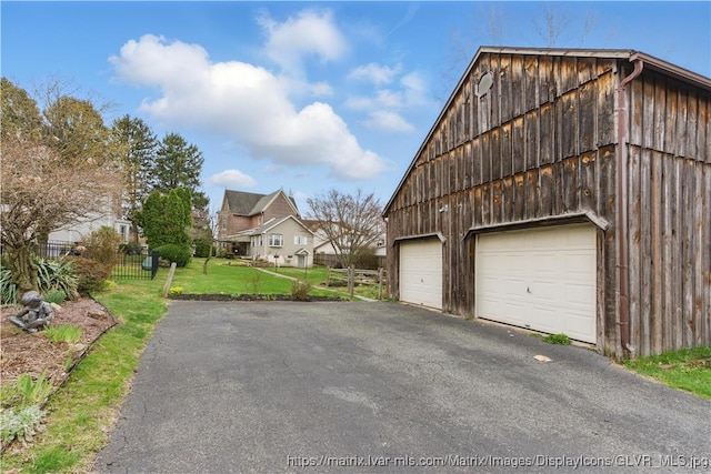 221 Franklin St, Alburtis Borough, PA 18011 - view of home's exterior featuring a barn, an outbuilding, a garage, fence, and a lawn