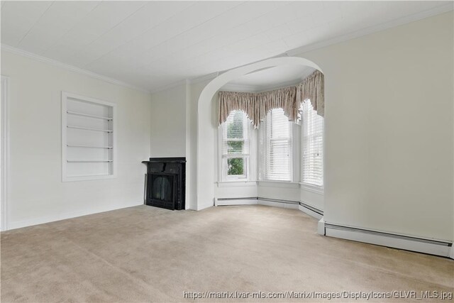 221 Franklin St, Alburtis Borough, PA 18011 - unfurnished living room featuring built in shelves, a fireplace, crown molding, carpet flooring, and a baseboard heating unit