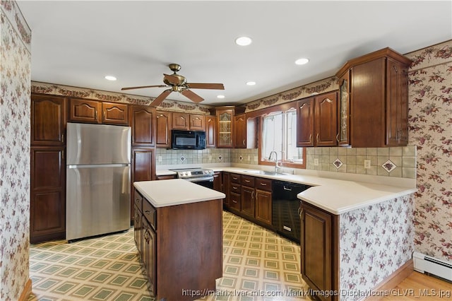 221 Franklin St, Alburtis Borough, PA 18011 - kitchen featuring a baseboard heating unit, light floors, black appliances, ceiling fan, and a sink
