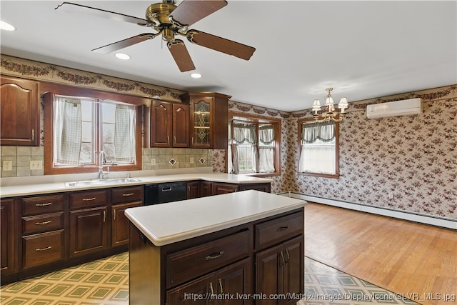 221 Franklin St, Alburtis Borough, PA 18011 - kitchen featuring baseboard heating, black dishwasher, a wall mounted AC, a sink, and light countertops