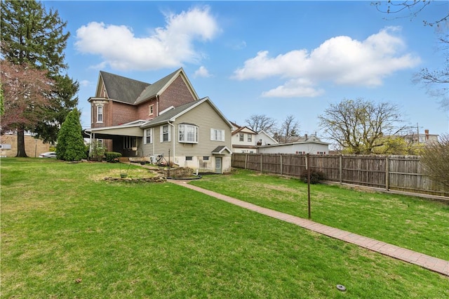 221 Franklin St, Alburtis Borough, PA 18011 - rear view of property with fence and a lawn