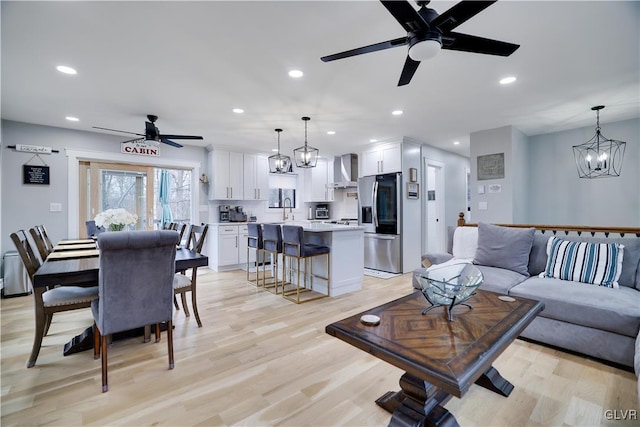 5627 Pembrook Dr, Coolbaugh Twp, PA 18466 - living room featuring a ceiling fan, recessed lighting, light wood-style flooring, and a chandelier