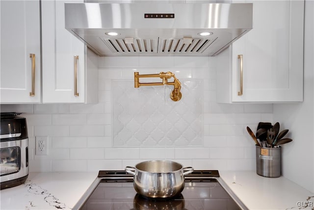 5627 Pembrook Dr, Coolbaugh Twp, PA 18466 - kitchen featuring extractor fan, white cabinets, and decorative backsplash