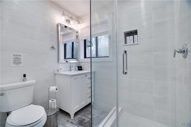 5627 Pembrook Dr, Coolbaugh Twp, PA 18466 - bathroom with vanity, a shower stall, tile walls, and tile patterned floors
