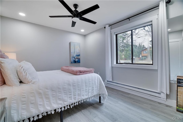 5627 Pembrook Dr, Coolbaugh Twp, PA 18466 - bedroom featuring wood finished floors, ceiling fan, recessed lighting, and a baseboard radiator