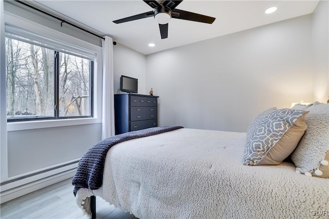 5627 Pembrook Dr, Coolbaugh Twp, PA 18466 - bedroom featuring a baseboard heating unit, recessed lighting, wood finished floors, and a ceiling fan