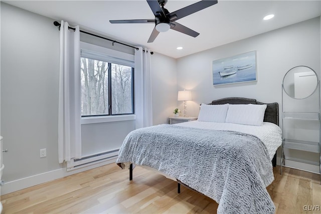 5627 Pembrook Dr, Coolbaugh Twp, PA 18466 - bedroom featuring a baseboard heating unit, wood finished floors, a ceiling fan, and recessed lighting
