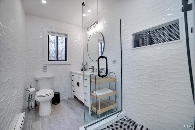 5627 Pembrook Dr, Coolbaugh Twp, PA 18466 - bathroom featuring a baseboard heating unit, tile walls, vanity, a stall shower, and recessed lighting