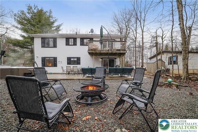 5627 Pembrook Dr, Coolbaugh Twp, PA 18466 - back of house featuring an outdoor fire pit, a hot tub, a patio area, a storage shed, and a balcony