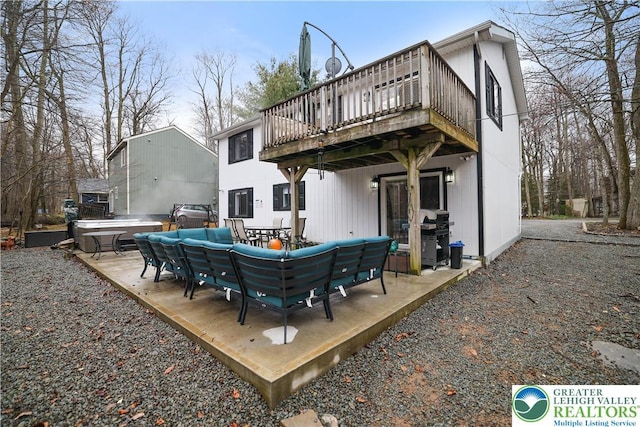 5627 Pembrook Dr, Coolbaugh Twp, PA 18466 - rear view of house featuring a hot tub, a wooden deck, an outdoor hangout area, and a patio area