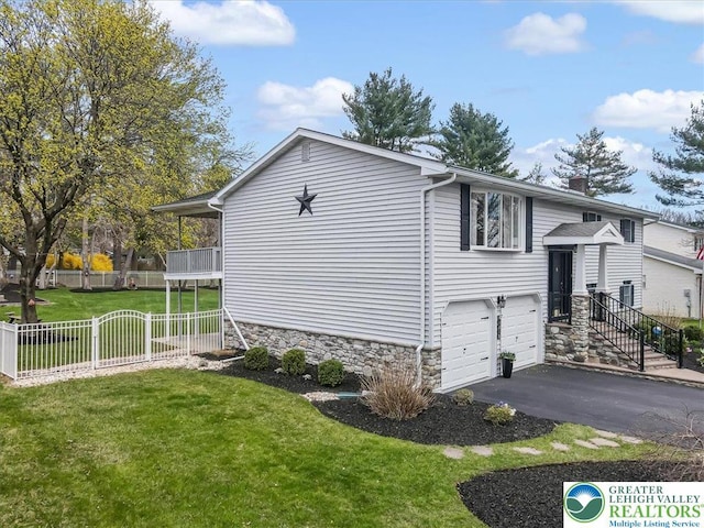 view of property exterior featuring an attached garage, a lawn, a chimney, aphalt driveway, and fence