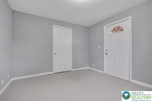 carpeted empty room featuring baseboards
