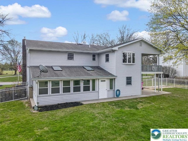 rear view of property featuring fence, a yard, a patio area, and a chimney