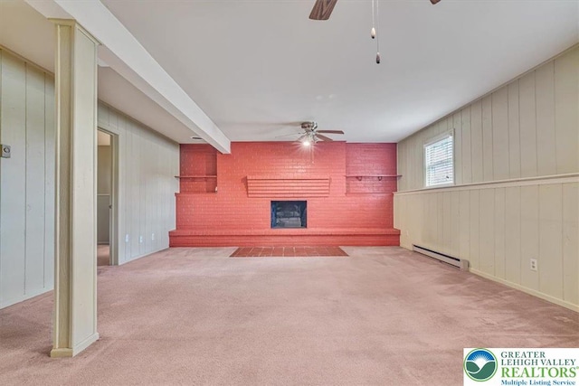 unfurnished living room featuring baseboard heating, a fireplace, a ceiling fan, and carpet