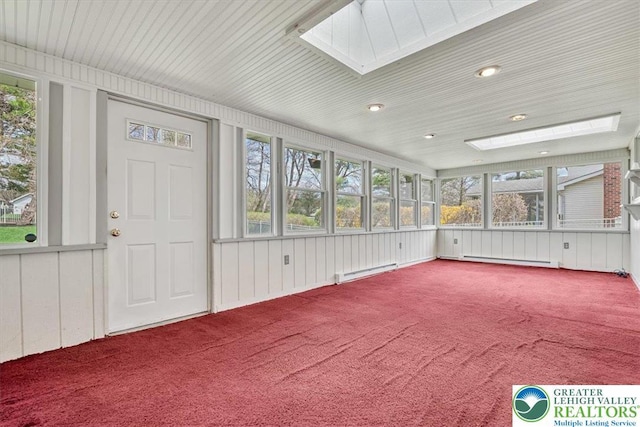 unfurnished sunroom with baseboard heating, a skylight, and a baseboard heating unit